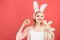 Happy woman in bunny ears with toy. Spring holiday. Girl with hare toy. Woman in rabbit bunny ears. Happy easter. Egg