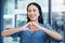 Happy woman, call center and portrait with heart hands in customer service, support or telemarketing at office. Female