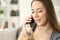 Happy woman calling doctor asking about bottle of pills