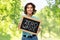 Happy woman with chalkboard with zero waste words