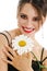 Happy woman with chamomile flower