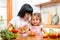 Happy woman and child preparing healthy food together