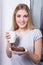 Happy woman with chocolate cake and cup of coffee