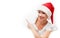 Happy woman with christmas hat peeking through a hole torn in w