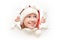 Happy woman with christmas hat peeking through a hole torn in white paper poster