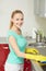 Happy woman cleaning cooker at home kitchen