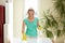 Happy woman cleaning table at home kitchen