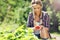 Happy woman collecting fresh strawberries in the garden