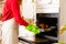 Happy woman cooking thanksgiving turkey at kitchen