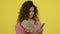 Happy woman counting money cash on yellow background. Woman count cash money