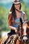 Happy woman, countryside and portrait with cowgirl in horse riding for journey or outdoor adventure in nature. Female