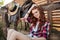 Happy woman cowgirl sitting on farm