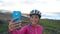 Happy woman cyclist taking selfie at using smart phone