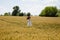 Happy woman dance in wheat field. feel the freedom. carefree girl in white dress. summer harvest and agriculture. country nature.