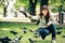 Happy woman with doves in park