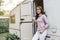 Happy woman drinking coffee at door of a camper RV van motorhome