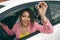 Happy woman driver hold car keys in her new car