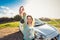 Happy woman driver hold car keys near her new car