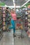 Happy Woman Driving Shopping Cart in Supermarket