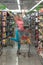 Happy Woman Driving Shopping Cart in Supermarket