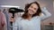 Happy woman drying hair at home. Portrait of brunette woman blowing hair