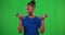 Happy woman, dumbbell and workout on green screen in strong power, wellness exercise and bodybuilding strength. Portrait