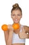 Happy woman with dumbbells fruits