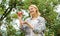 Happy woman eating apple. orchard, gardener girl in apple garden. vitamin and dieting food. healthy teeth. hunger