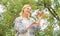 Happy woman eating apple. orchard, gardener girl in apple garden. vitamin and dieting food. healthy teeth. hunger