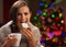 Happy woman eating Christmas cookie