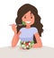 Happy woman is eating a salad. Vegetarian. The concept of proper nutrition and healthy lifestyle