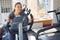 Happy woman is engaged on a stationary bike