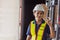 Happy woman engineer worker Asian Latin Indian. lady staff in safety suit work in large factory warehouse cute action