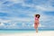 Happy woman enjoy the beach. White sand, crystal-blue sea of tropical beach. Vacation at Paradise. Happy island lifestyle. Ocean