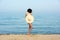 Happy woman enjoying beach relaxing joyful in summer by blue water.