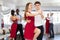 Happy woman enjoying impassioned merengue with male partner in dance room during party. Social dancing concept