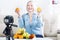 Happy woman expert nutritionist shows fruits to the camera at home.