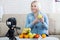Happy woman expert nutritionist shows fruits to the camera in studio.