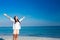 Happy woman with eyes closed at the beach