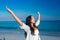 Happy woman with eyes closed at the beach