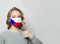 Happy woman in face mask holding thumb up with national flag Czech Republic background. Flu epidemic and protection concept