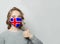 Happy woman in face mask holding thumb up with national flag Iceland background. Flu epidemic and virus protection concept