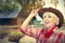 Happy woman farmer posing on ranch background