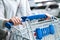 Happy woman female with closeup shopping cart or trolley in car parking of fresh maket for healthy housewife in supermarket store