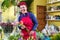 Happy woman florist, making arrangements, and smiling at camera. small business Flower shop owner.