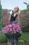 Happy woman with flowers in her garden