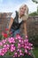 Happy woman with flowers in her garden