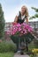 Happy woman with flowers in her garden