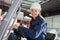 happy woman forklift truck driver in industrial area