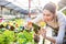 Happy woman gardener taking picture of plants with smartphone